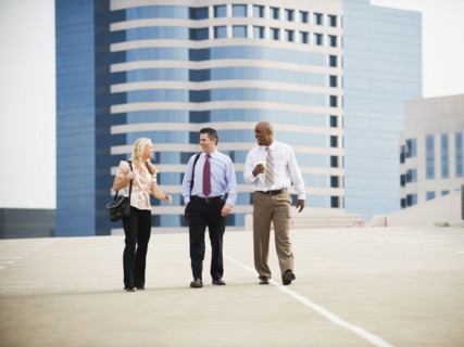 Co-workers walking in parking lot.