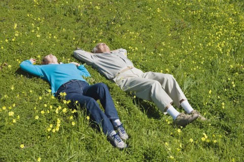 Couple relaxing in meadow.