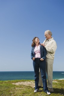 Couple standing near the ocean.
