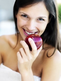Woman eating an apple. Photographe : momentimages