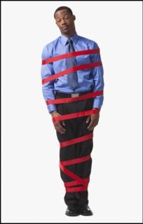 Businessman wrapped in red tape. Photographe : Mike Kemp