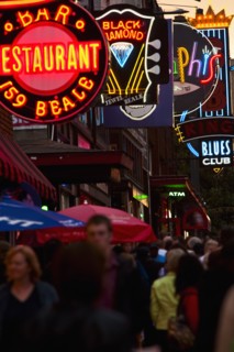 Crowd of people and Illuminated signs on Beale Street.