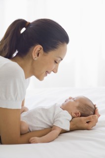 Mother holding her sleeping baby.