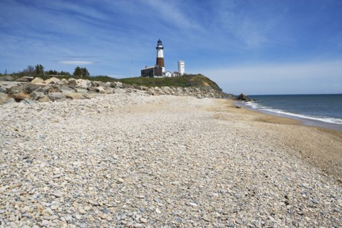 Beach with lighthouse in background. Photo : fotog