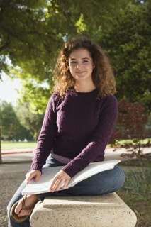 Teenage student sitting on park bench. Photo : Stewart Cohen