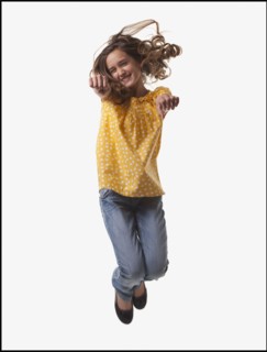 Excited teenage girl jumping for joy. Photo : Mike Kemp