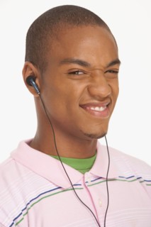 Man wearing earphones making a funny face. Photo : K.Hatt