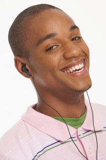 Smiling man wearing earphones. Photo : K.Hatt
