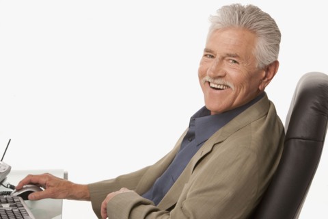 Businessman relaxing at his desk. Photo : K.Hatt