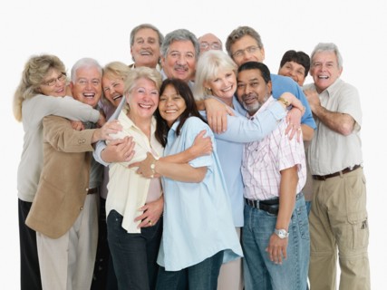 A group of people embracing. Photo : momentimages