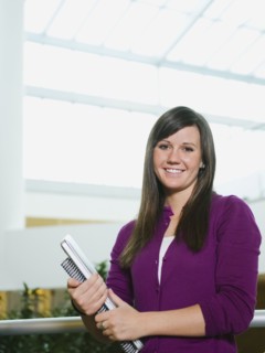 College student holding books.