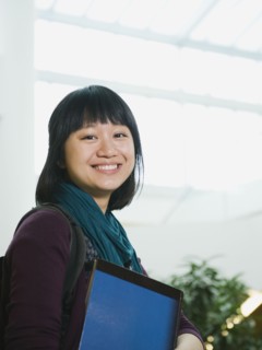 College student holding books.