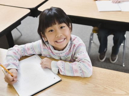 Elementary student writing in her notebook.