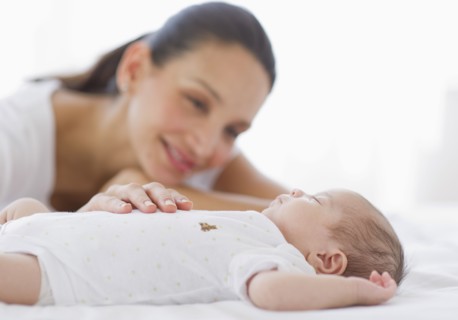 Mother watching her baby sleep.