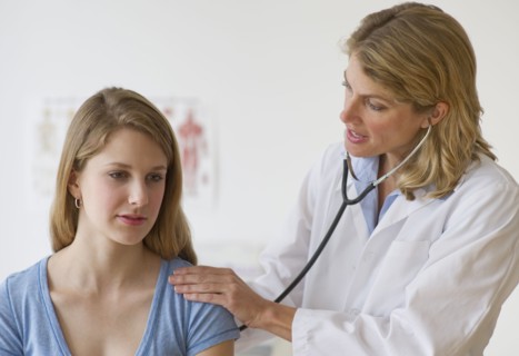 Doctor performing medical exam on patient.