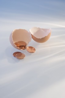 Pennies in a cracked egg shell.