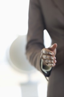 Hand extended for handshake.