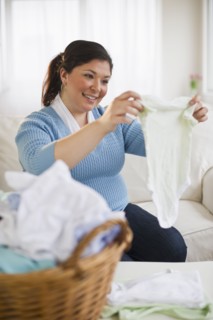 Overweight woman folding clothes.