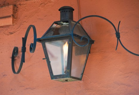 Lantern on an orange stucco wall.