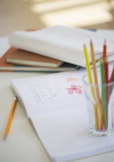 Child's notebook and colored pencils.