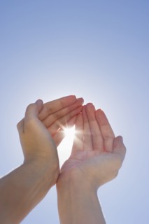Hands framing sunshine.
