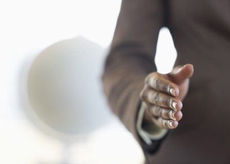 Hand extended for handshake.