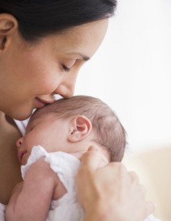 Mother kissing her baby's head.