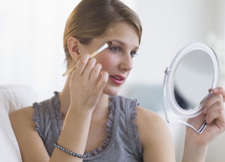 Woman putting on makeup.