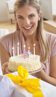Woman holding birthday cake.