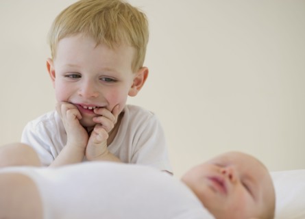 Brother watching his baby brother sleep. Photo : Chris Grill