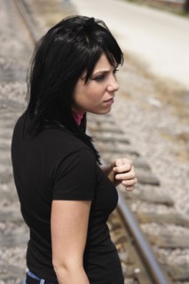 Woman standing on railroad tracks. Photo : Stewart Cohen