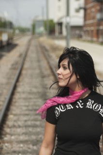 Woman standing on railroad tracks. Photo : Stewart Cohen