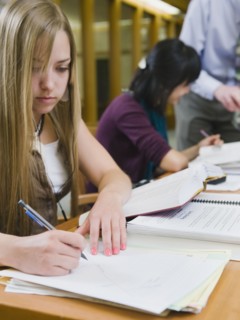 College students working in library.