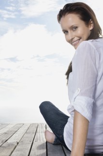 Pretty woman sitting on porch. Photo : momentimages