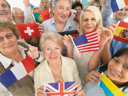 A group of people holding small flags. Photo : momentimages
