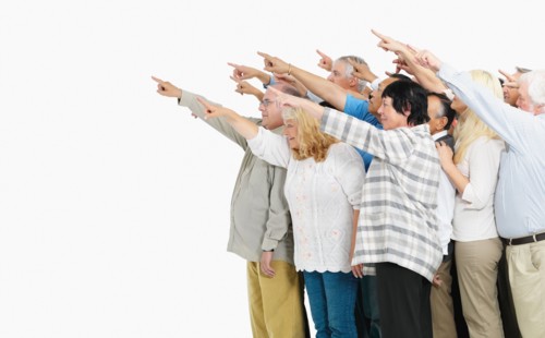 A group of people pointing. Photo : momentimages