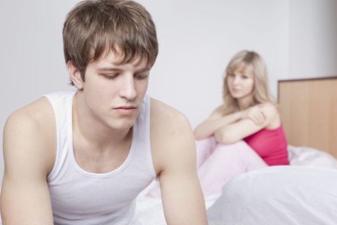 Couple sitting on bed after arguing. Photo : Take A Pix Media