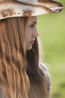 Side profile of a beautiful long haired cowgirl. Photo : Mike Kemp