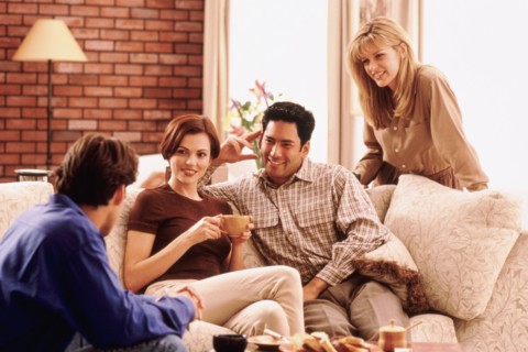 Four friends socializing in living room. Photo : Rob Lewine