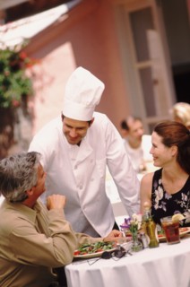 Chef talking to patron. Photo : Rob Lewine