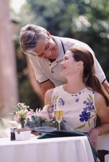 Happy couple having meal on patio. Photo : Rob Lewine