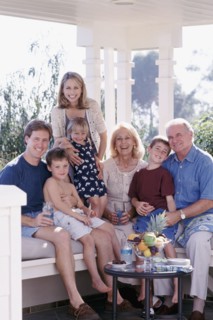 Three generations of family sitting on porch together. Photo : Rob Lewine