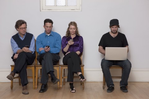 Four people sitting in a row. Photo : Dan Bannister