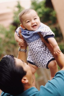Happy father holding his infant son. Photo : Rob Lewine