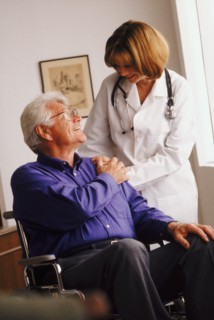 Doctor talking to senior man in wheelchair. Photo : Rob Lewine