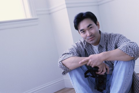 Relaxed man sitting on the floor in his home. Photo : Rob Lewine
