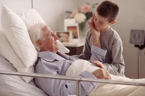 Grandson visiting Grandfather in hospital. Photo : Rob Lewine
