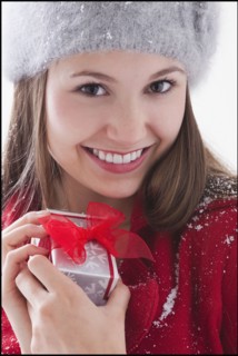 Woman holding small Christmas present. Photo : Mike Kemp