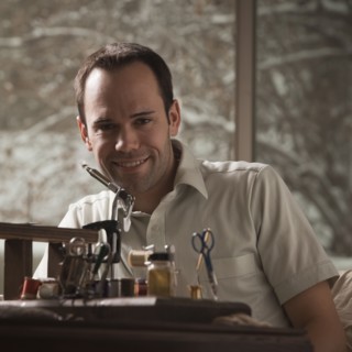 Man sitting behind fishing repair equipment. Photo : Mike Kemp