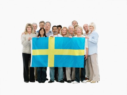 Group of people holding the Swedish flag. Photo : momentimages